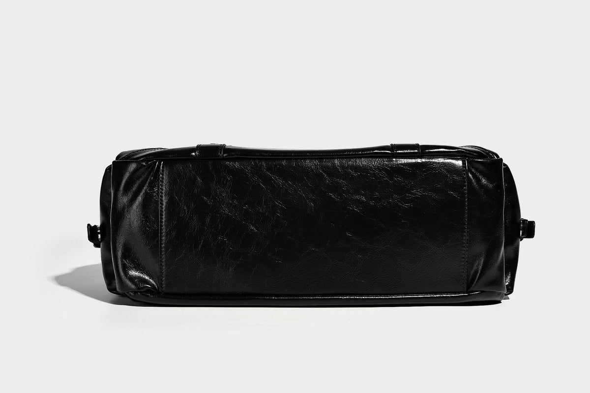 Glossy structured black tote shoulder bag with silver buckle hardware, zip pockets, dual top handles, and detachable, detail