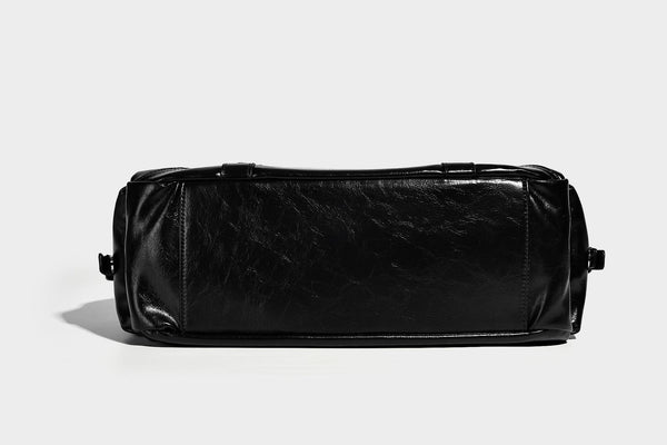 Glossy structured black tote shoulder bag with silver buckle hardware, zip pockets, dual top handles, and detachable, detail