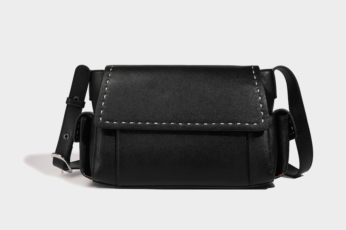 Structured flap crossbody bag in dark brown and cream color-block with white contrast stitching, adjustable shoulder strap