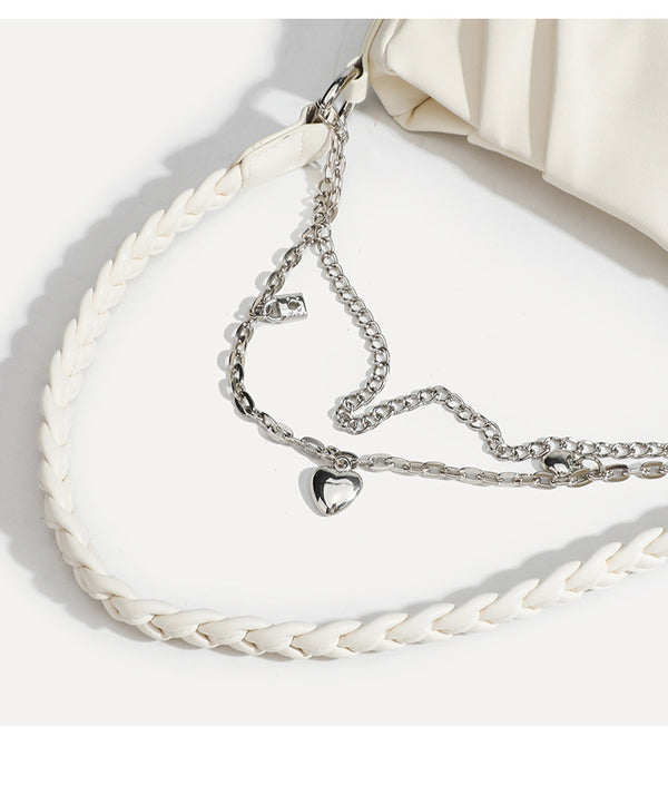 Slouchy hobo shoulder bag with gathered leather-look panels, silver-tone chain with charm pendants, and braided strap, detail