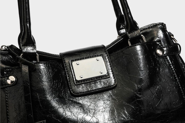 Structured glossy crinkled leather-look satchel with double top handles, front metal-plaque tab, silver-tone hardware, and