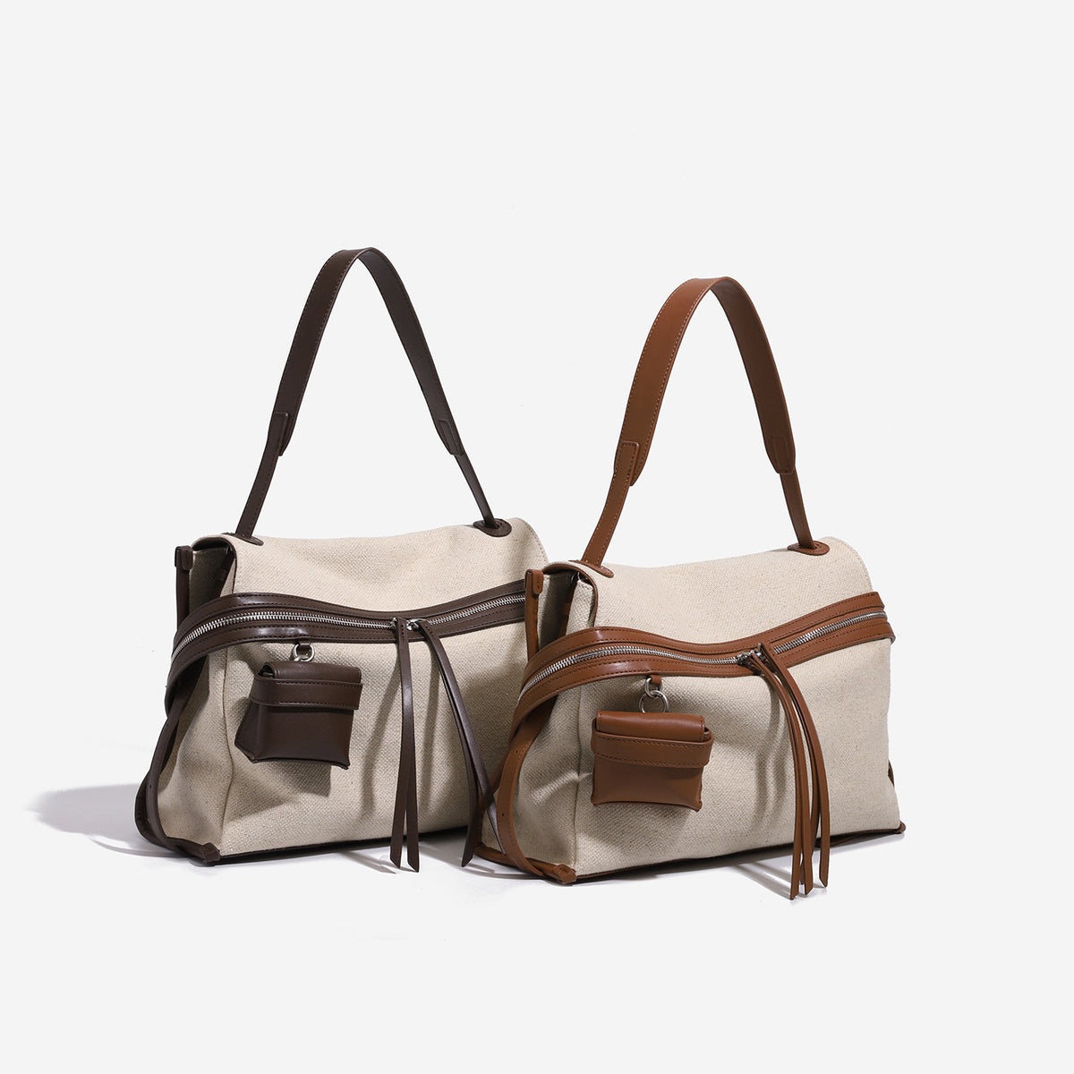 Cream canvas messenger shoulder bag with tan leather-look trim, dual zippers, tassel pulls, and attached mini front pouch