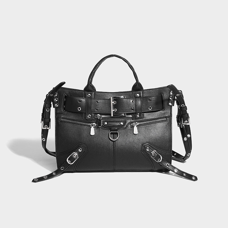 Black structured rectangular satchel bag with silver-tone rivets, large front buckle strap, zip pockets, dual top handles