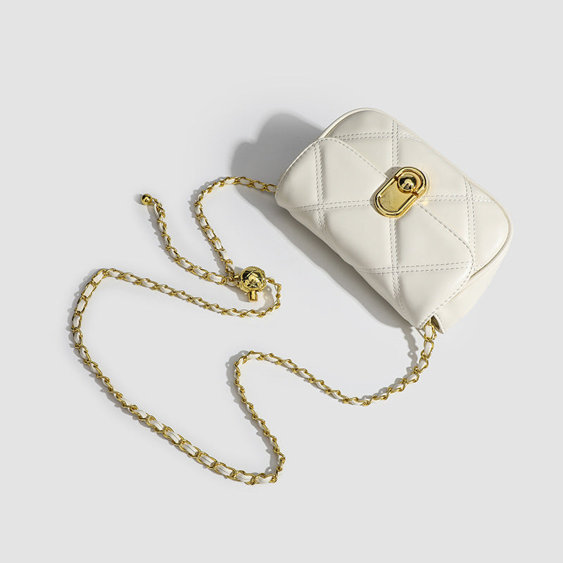 Compact diamond-quilted mini crossbody bag with gold-tone turn-lock closure and woven chain strap, detail view 4