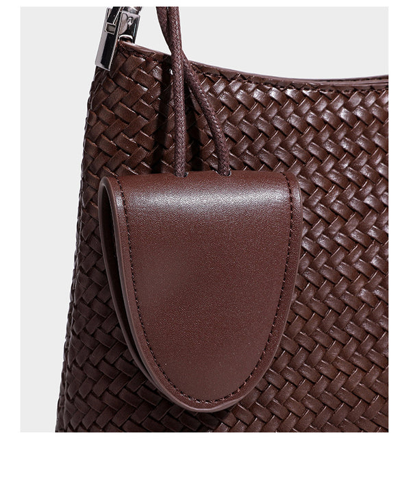 Woven-texture hobo shoulder bag in brown with braided top handle, adjustable crossbody strap, front flap pocket, and, detail
