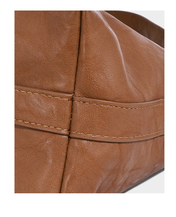 Slouchy leather-look hobo shoulder bag with gold-tone hardware and adjustable strap in brown, detail view 12