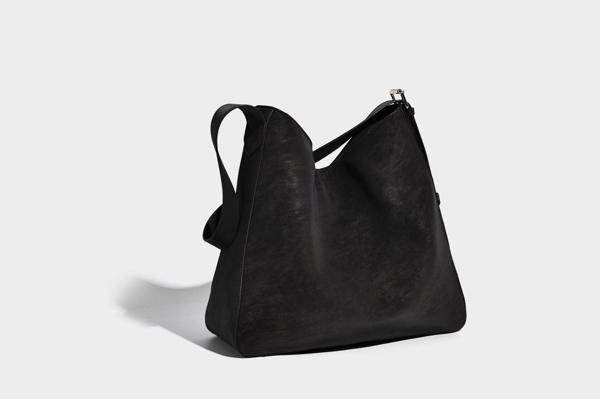 Large slouchy hobo shoulder bag in matte leather-look finish with adjustable strap and gold-tone bar hardware, detail view 23
