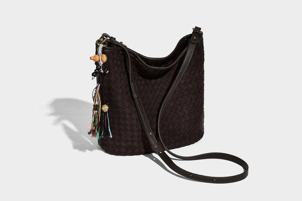 Dark chocolate woven texture hobo shoulder bag with multicolor tassel-and-bead charm and long adjustable strap, detail view