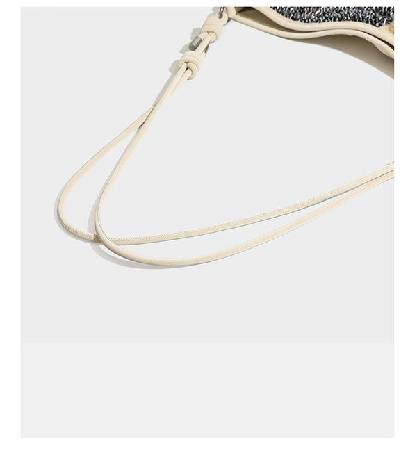Slouchy hobo shoulder bag with black bugle-bead sequin and cream bouclé patchwork panels, adjustable cream leather-look