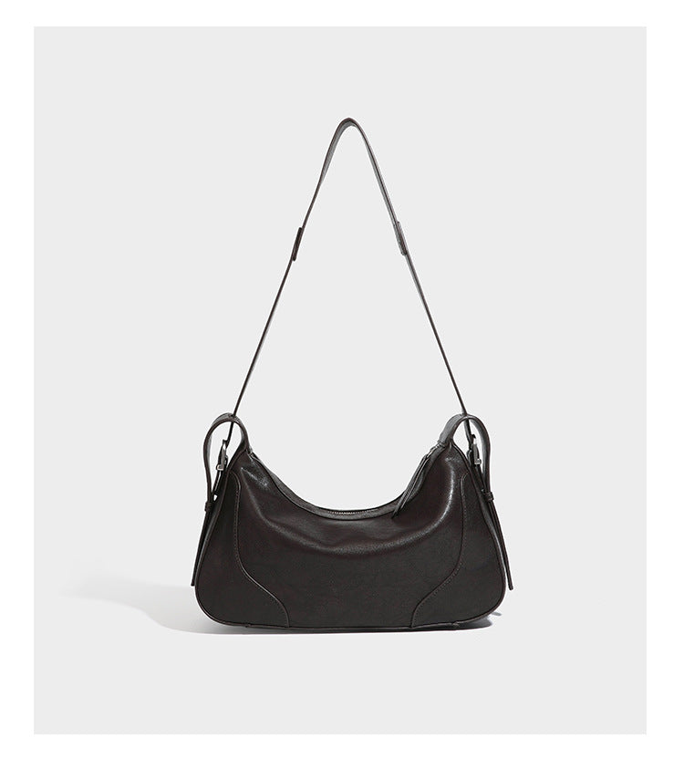 Slouchy crescent hobo shoulder bag in dark brown pebbled leather-look finish with zip top and long shoulder strap, detail