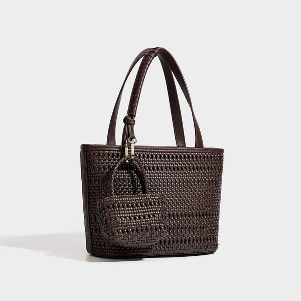 Structured open-weave tote bag with smooth leather-look trim, double top handles, detachable crossbody strap, and mini zip