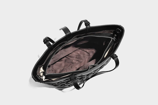 Structured woven lattice cutout tote bag with smooth leather-look trim, dual shoulder straps, and silver-tone hardware