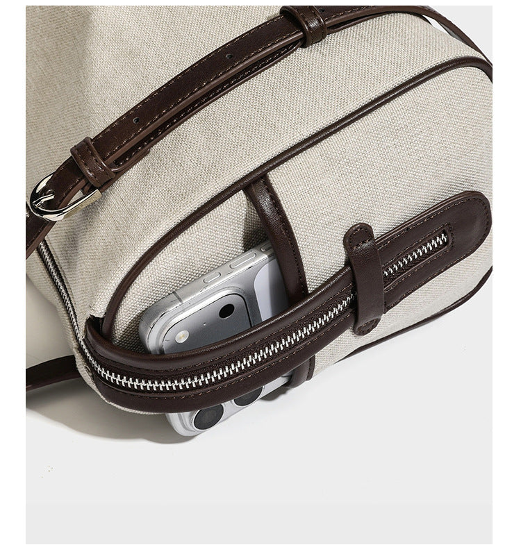 Cream canvas barrel shoulder bag with dark brown leather-look straps, trim, and silver-tone hardware, detail view 15