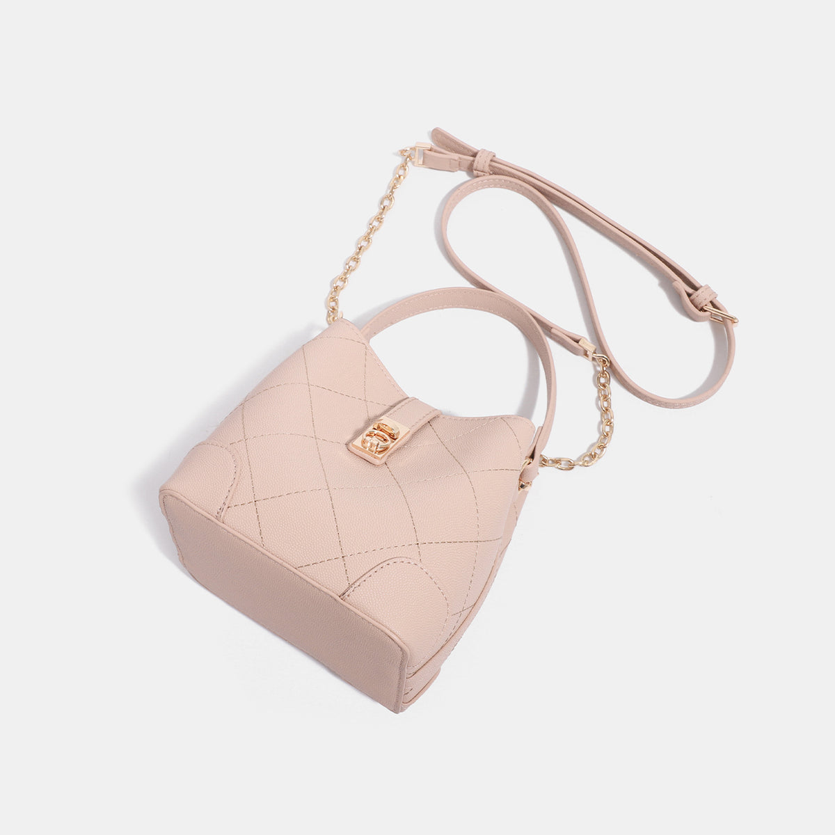 Mini diamond-quilted pebbled-finish bucket bag with gold-tone turn-lock closure and top handle, detail view 4