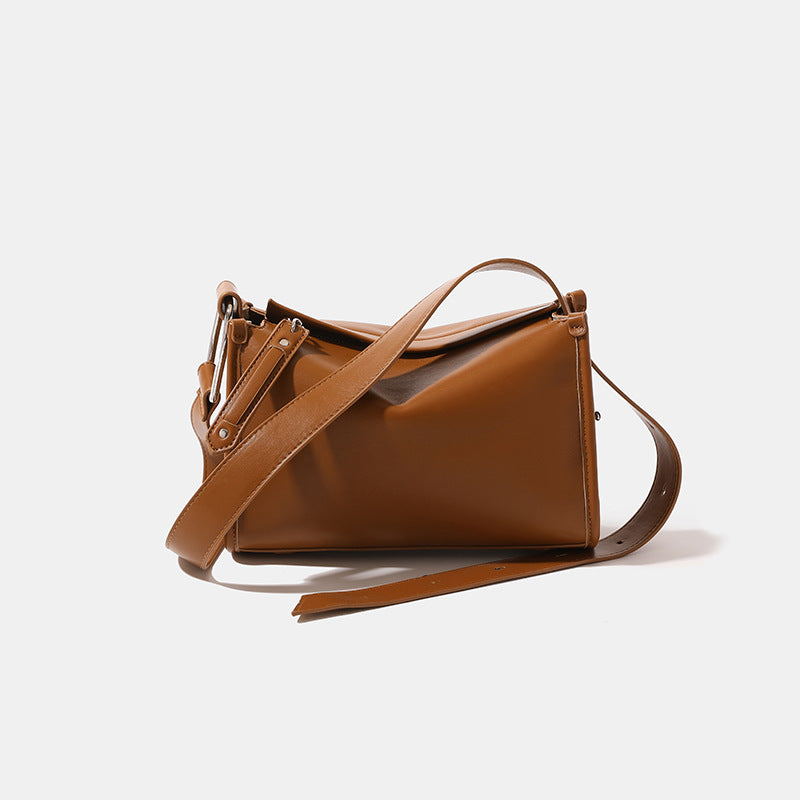Structured smooth leather-look shoulder bag with top zip closure, tassel pull, and adjustable crossbody strap in khaki