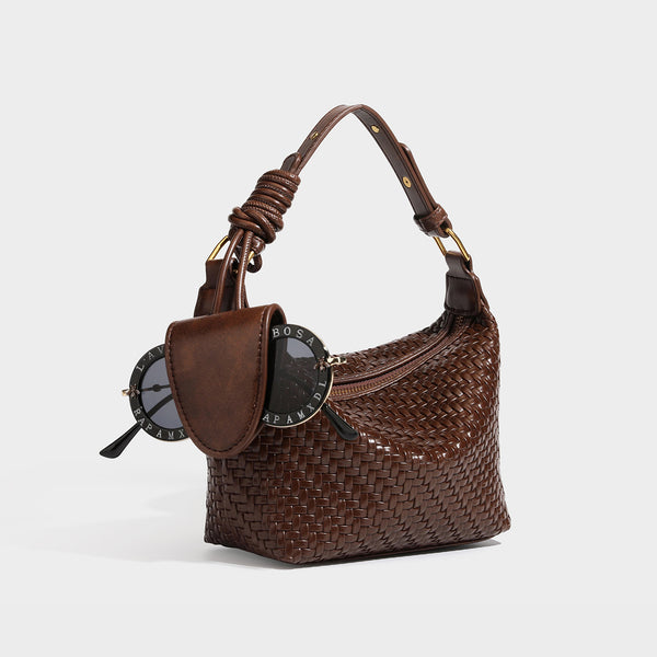 Small glossy basket-weave hobo shoulder bag in brown with knotted top handle, flap accent pocket, and gold-tone hardware