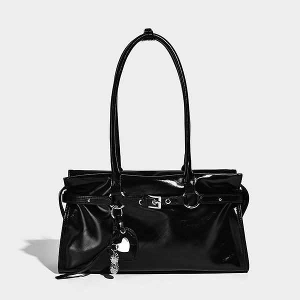 Structured rectangular glossy tote shoulder bag with belt buckle front strap and dangling charm hardware, detail view 7