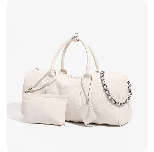 Large cream white pebbled leather-look barrel travel bag with twin top handles, chunky chain shoulder strap, front zip