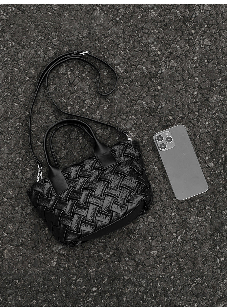 Small black glossy woven tote bag with dual top handles and detachable shoulder strap, detail view 12