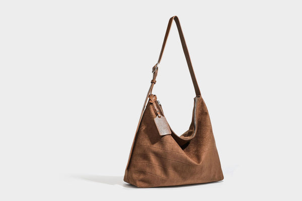 Slouchy hobo shoulder bag in matte croc-embossed leather-look finish with top zip closure and long adjustable strap, detail