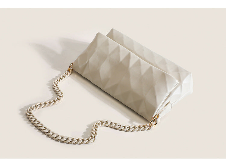 Cream white rectangular flap shoulder bag with geometric faceted surface and chunky tone-on-tone chain strap with gold-tone