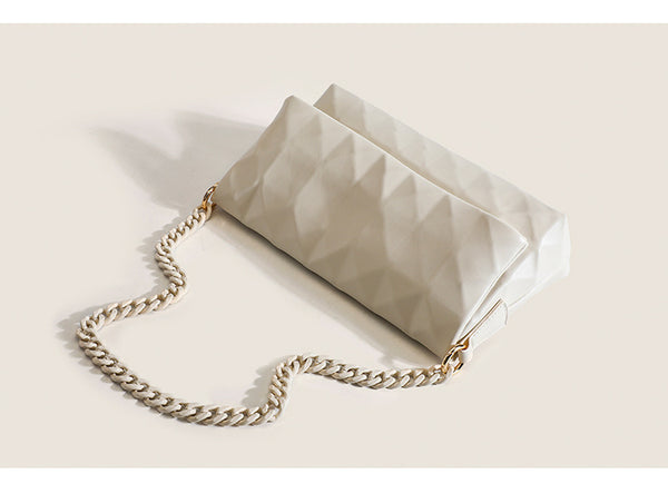 Cream white rectangular flap shoulder bag with geometric faceted surface and chunky tone-on-tone chain strap with gold-tone
