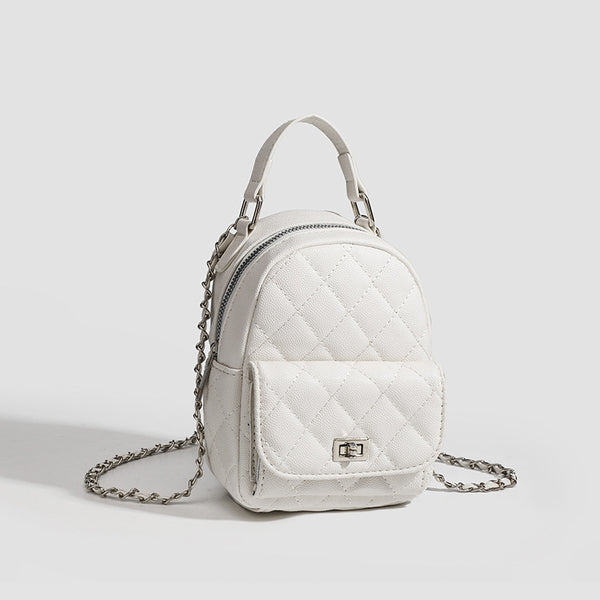 Compact diamond-quilted mini backpack handbag with silver-tone chain straps and turn-lock front pocket, detail view 3