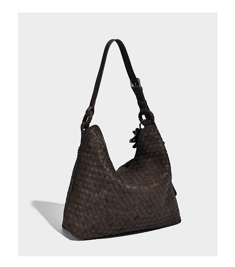 Large soft woven hobo shoulder bag with matte textured finish, adjustable strap, and star charm hardware, detail view 11