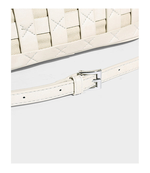 Small structured woven satchel tote with rounded top handles, silver-tone ring hardware, and bead tassel charm, detail view