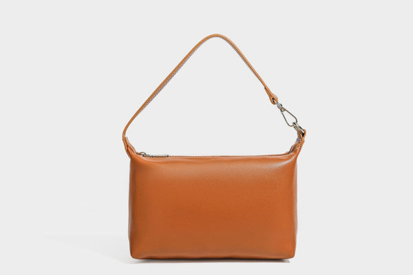 Large cream and navy striped canvas bucket tote bag with tan leather-look trim, drawstring closure, and double shoulder