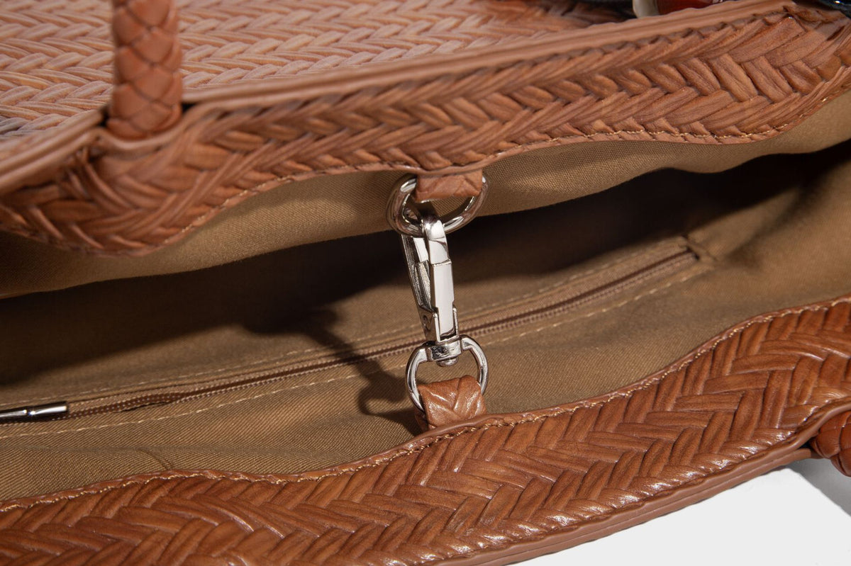 Structured woven herringbone tote bag with braided double shoulder handles in tan brown, shown with matching drawstring