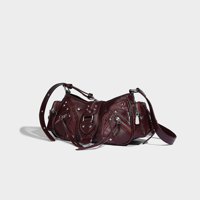 Compact glossy leather-look crossbody bag with silver studs, buckle hardware, and multiple zip pockets, detail view 3