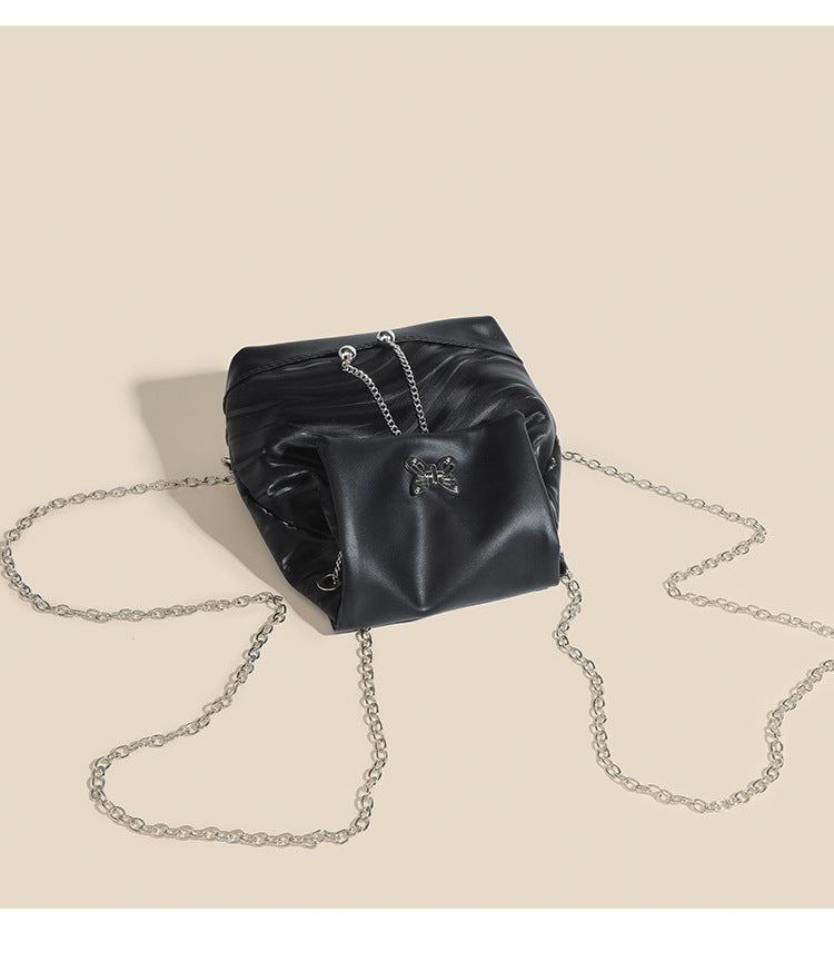 Compact ripple-embossed leather-look backpack handbag with silver butterfly clasp and chain straps, detail view 10