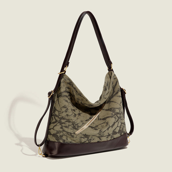Large ink-wash printed corduroy hobo bag with dark brown leather-look base trim, diagonal front zip pocket, and gold-tone
