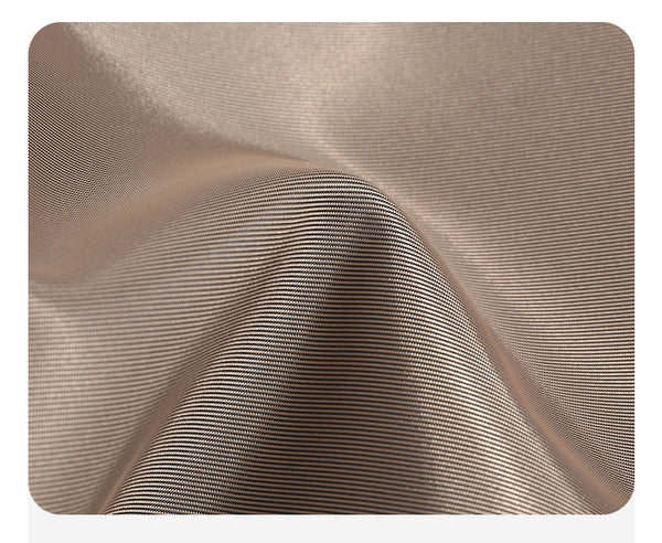 Large matte nylon backpack handbag with cognac leather-look trim, snap flap, and gold-tone hardware, detail view 10