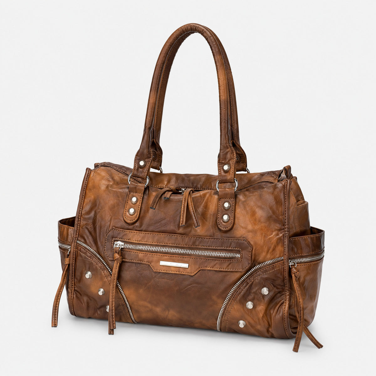 Large distressed leather-look moto tote bag with silver rivets, tassel zip pulls, front zip pocket, and dual top handles