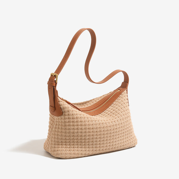 Beige woven raffia-style hobo shoulder bag with caramel leather-look trim, gold-tone zip closure, and adjustable strap