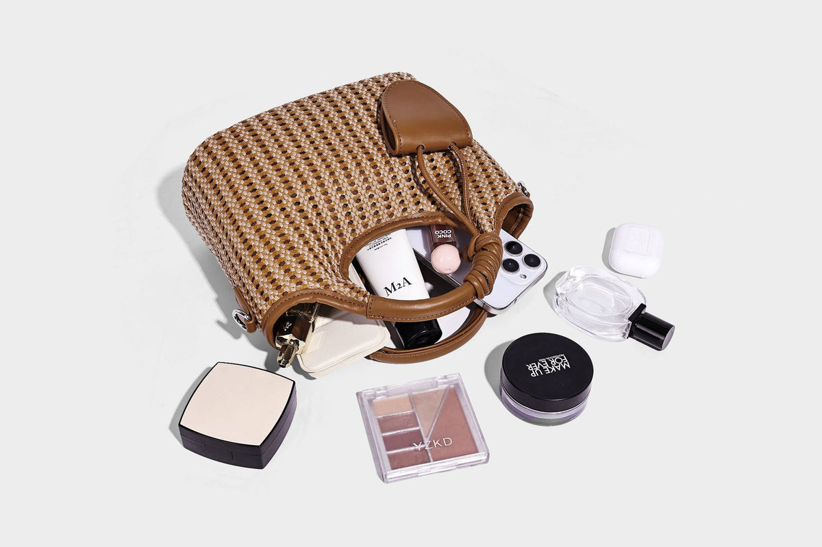 Small structured woven tote crossbody bag with ring top handle, leather-look brown trim, front patch pocket, and detachable