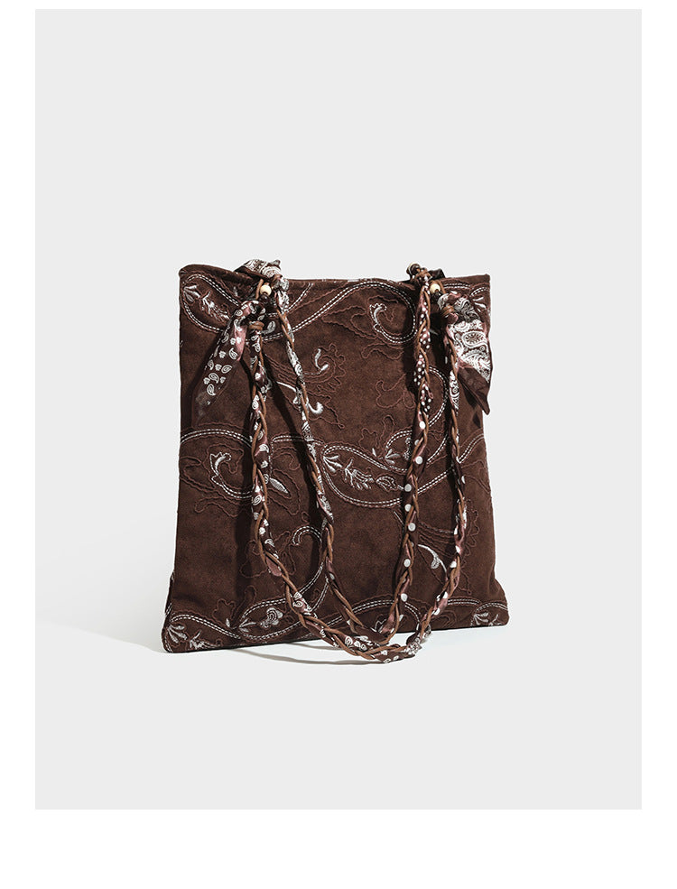 Brown suede-finish tote bag with paisley embroidery and braided fabric-ribbon shoulder strap, detail view 7
