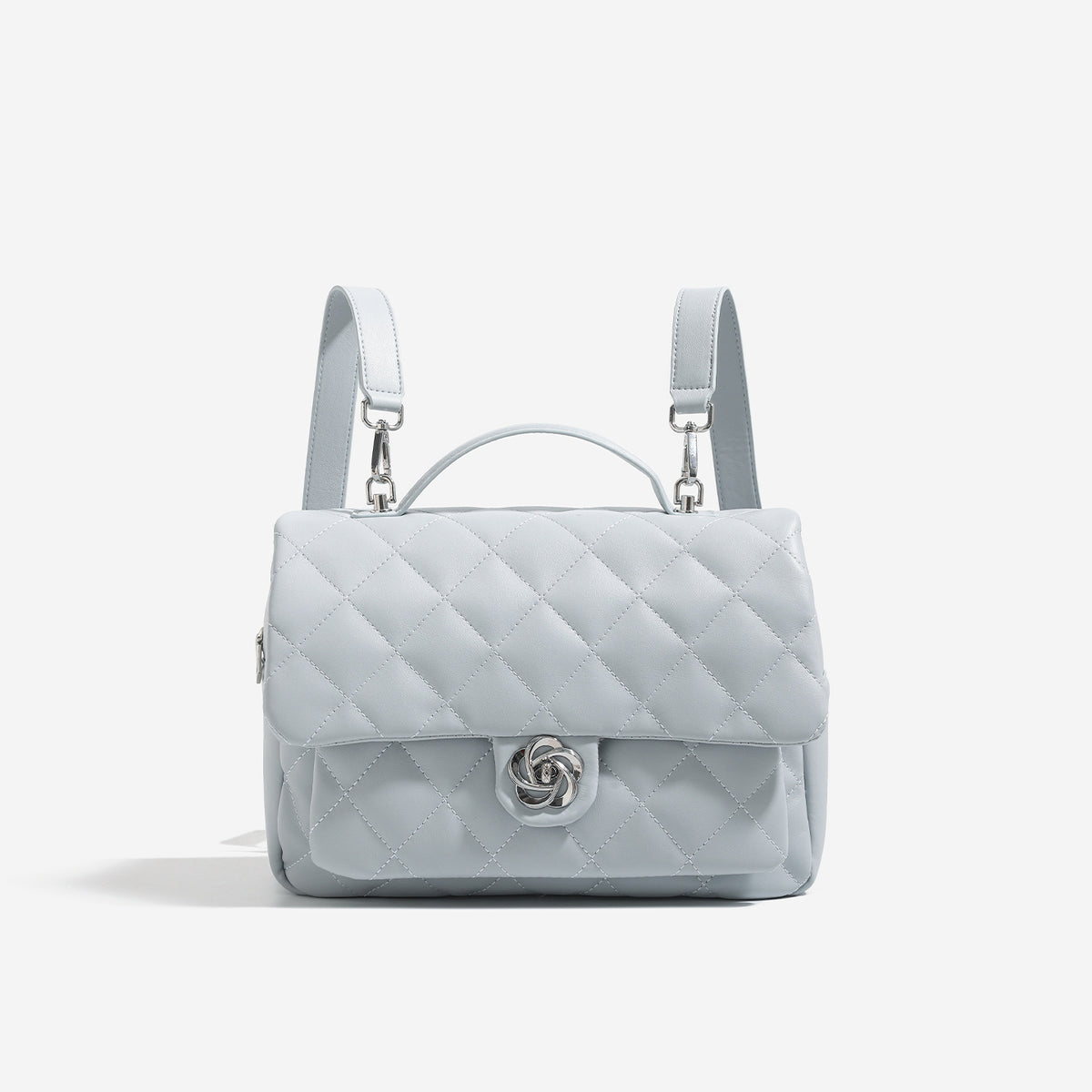 Diamond-quilted flap backpack handbag with silver-tone flower turn-lock, top handle, and dual shoulder straps, detail view 8
