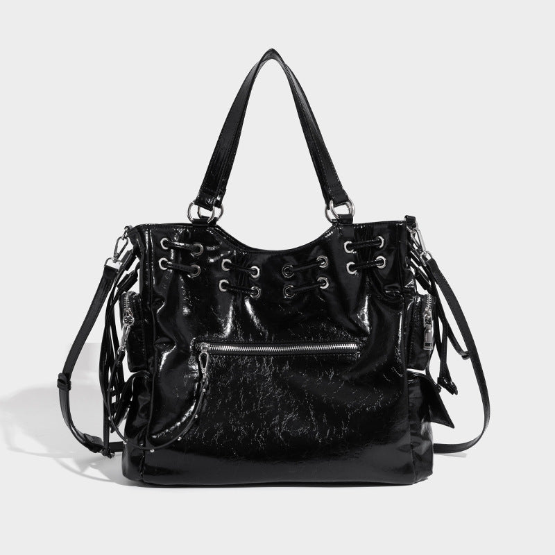 Glossy crinkled leather-look tote bag with silver grommet lace-up front detail, dual top handles, and detachable shoulder