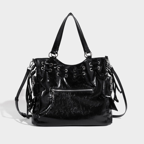 Glossy crinkled leather-look tote bag with silver grommet lace-up front detail, dual top handles, and detachable shoulder