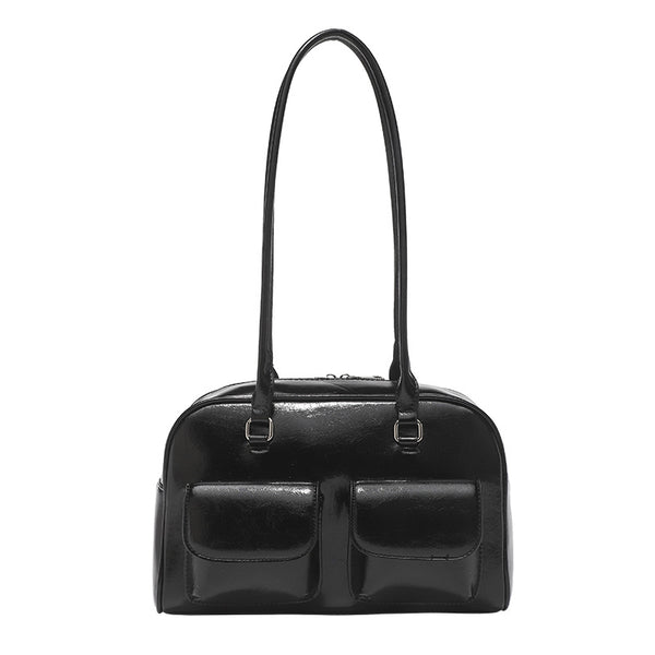 Structured glossy leather-look bowling shoulder bag with two front flap pockets, top zip closure, and long double shoulder