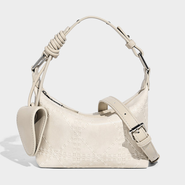 Small embossed half-moon shoulder bag with top zipper, detachable front pouch, and adjustable slim strap, detail view 6