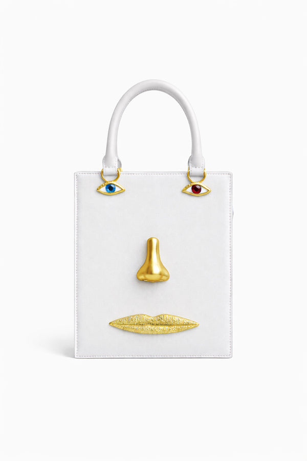 Structured rectangular top-handle bag in tan leather-look finish with gold-tone sculptural face hardware including