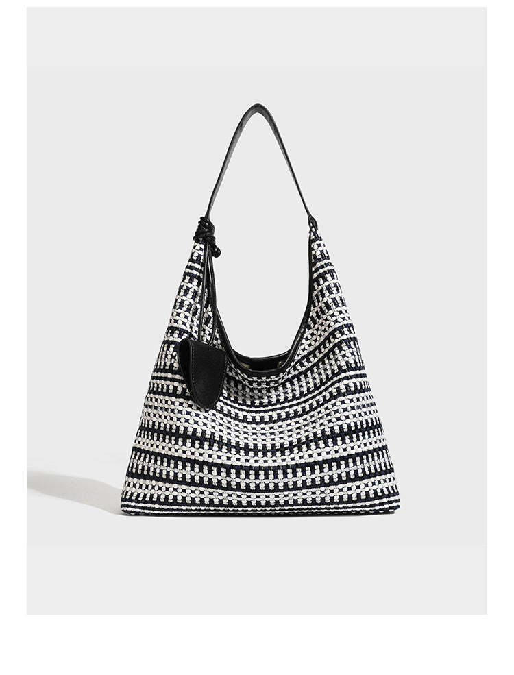 Slouchy woven stripe hobo shoulder bag with black-and-white pattern and leather-look strap, detail view 7