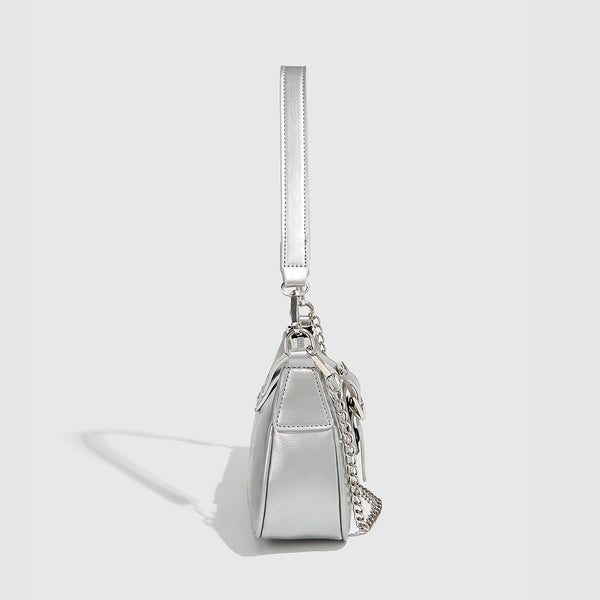 Compact metallic silver shoulder bag with glitter star appliqués, rhinestone star charms, front belt buckle strap, chunky