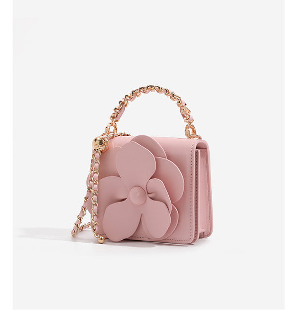Small structured rectangular crossbody bag with layered 3D flower appliqué and gold-tone chain strap, detail view 15