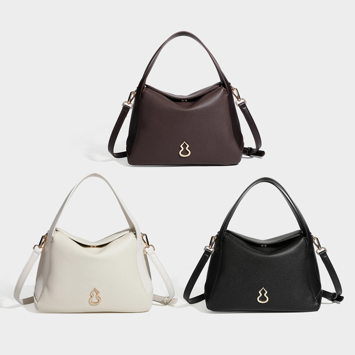 Structured pebbled leather-look shoulder bag with flap top, gold-tone emblem hardware, dual top handles, and detachable