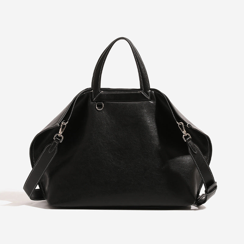 Structured cognac brown leather-look tote bag with fold-ear side panels, top handles, gold-tone hardware, and detachable